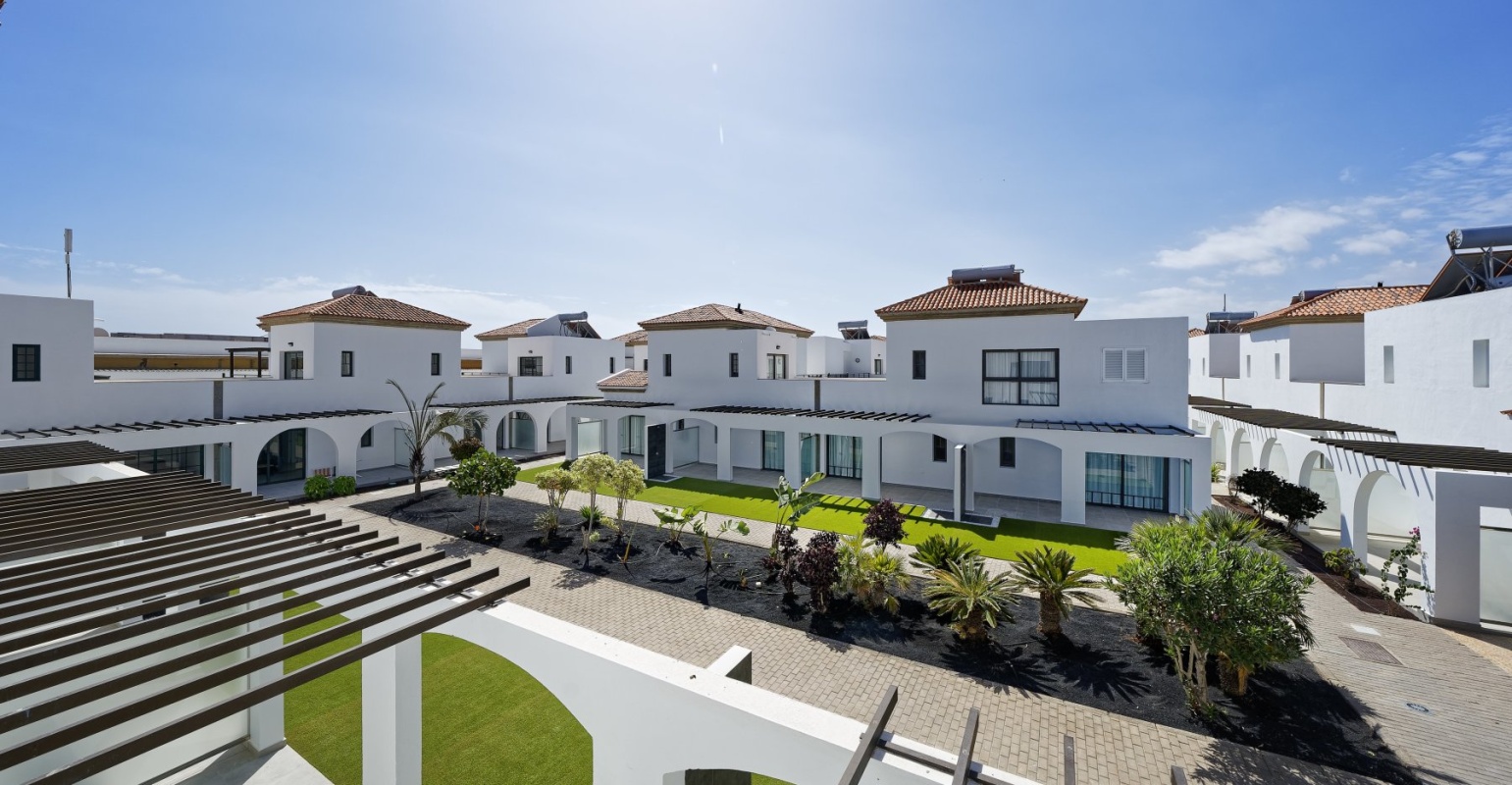 Aerial view of Broncemar Beach Suites Hotel in Fuerteventura, with village-like design, pedestrian streets and tropical gardens.